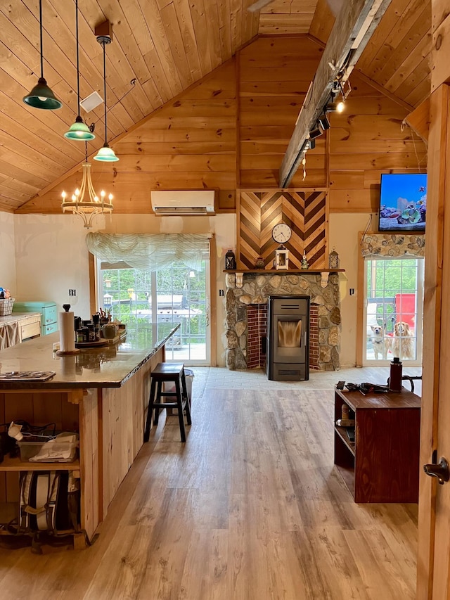 44 Webb Pond Rd, Eastbrook, ME 04634 - kitchen featuring a wall mounted AC, wooden ceiling, open shelves, light wood finished floors, and high vaulted ceiling
