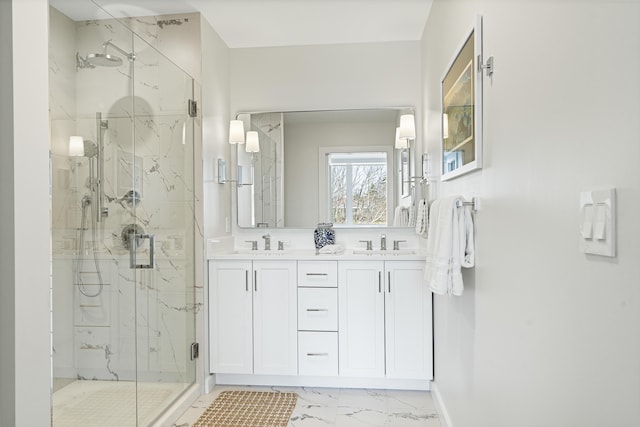bathroom featuring double vanity, a sink, marble finish floor, and a marble finish shower