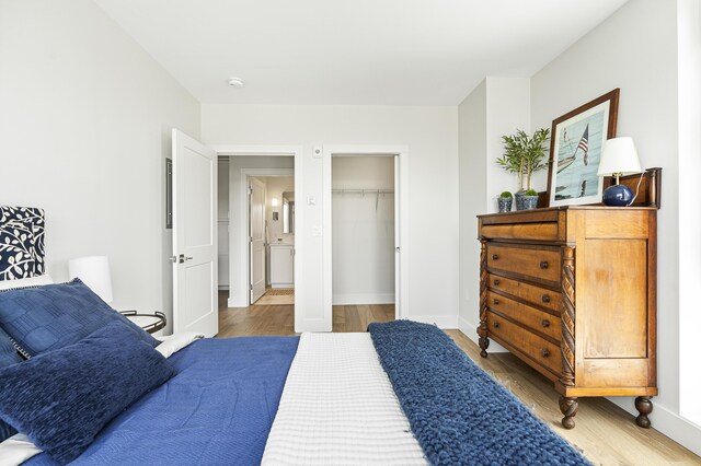 bedroom featuring baseboards and wood finished floors
