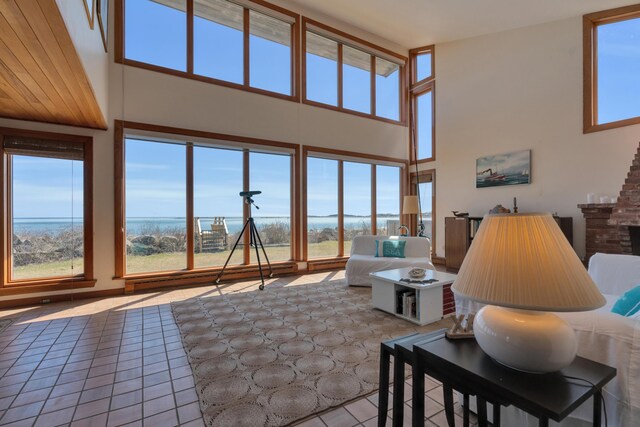 683 Kings Hwy, Kennebunkport, ME 04046 - living area featuring tile patterned floors, a high ceiling, and a wealth of natural light