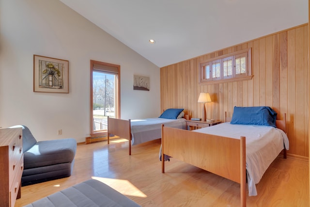 683 Kings Hwy, Kennebunkport, ME 04046 - bedroom featuring baseboards, wooden walls, recessed lighting, wood finished floors, and vaulted ceiling