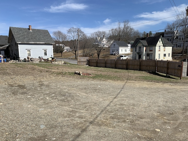 view of yard with a residential view and fence