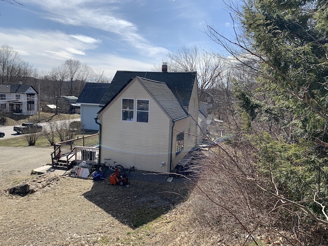 view of side of home with a chimney