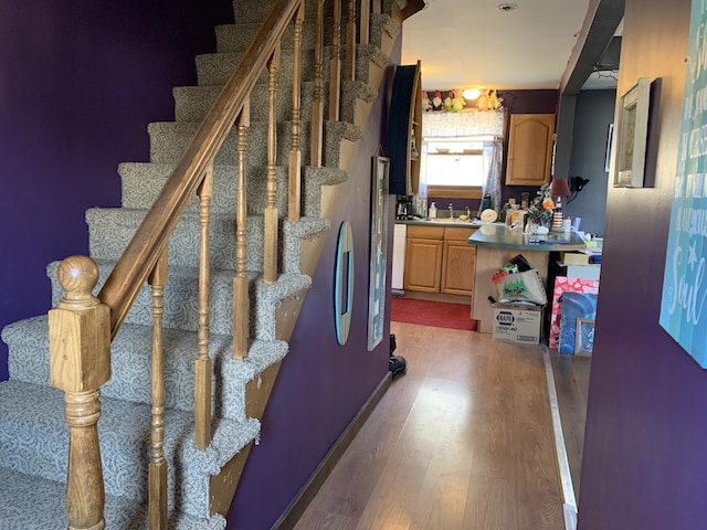 staircase featuring wood finished floors