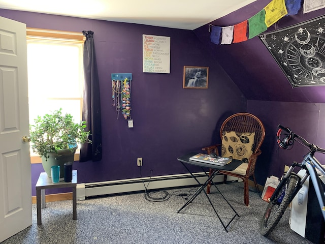 living area with a baseboard heating unit and lofted ceiling