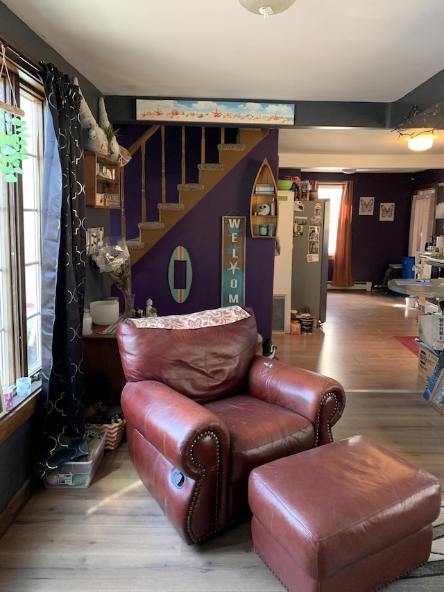 living room with stairway and wood finished floors
