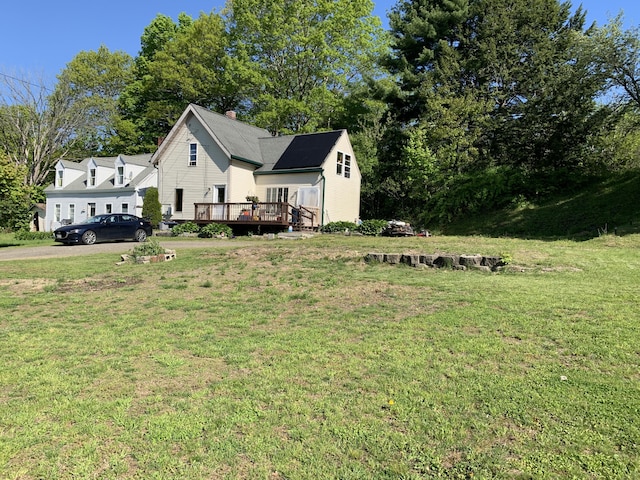 46 Windsor St, Randolph, ME 04346 - view of front facade featuring a deck, a front lawn, and a chimney