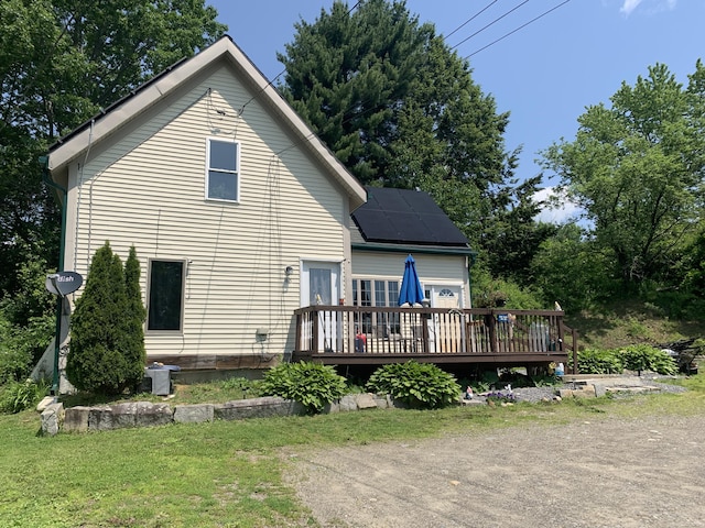 46 Windsor St, Randolph, ME 04346 - rear view of house with a deck and solar panels