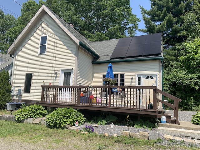 46 Windsor St, Randolph, ME 04346 - back of house with solar panels, a deck, and a shingled roof