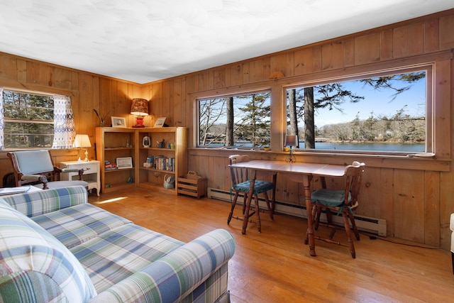 57 Samoset Trl, Boothbay, ME 04544 - bedroom featuring wooden walls, wood finished floors, a water view, and baseboard heating
