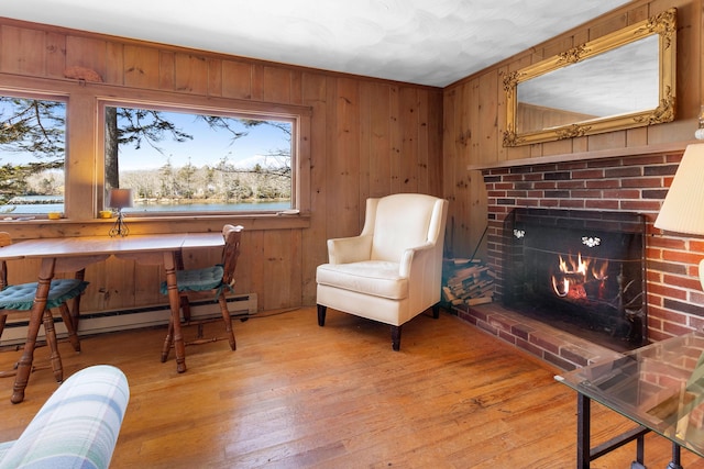 57 Samoset Trl, Boothbay, ME 04544 - sitting room with light wood-style floors, a brick fireplace, and a healthy amount of sunlight