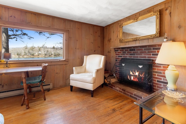 57 Samoset Trl, Boothbay, ME 04544 - living area with a fireplace, light wood-style floors, plenty of natural light, and wood walls