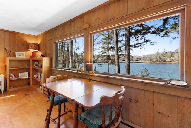 57 Samoset Trl, Boothbay, ME 04544 - dining space with light wood-type flooring, wood walls, and a water view