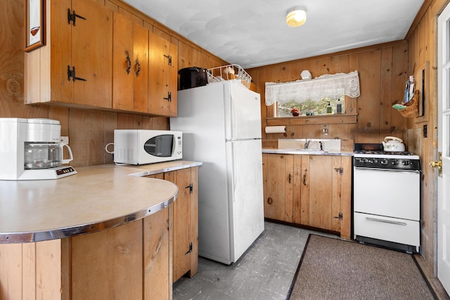 57 Samoset Trl, Boothbay, ME 04544 - kitchen with a sink, brown cabinets, wooden walls, white appliances, and light countertops