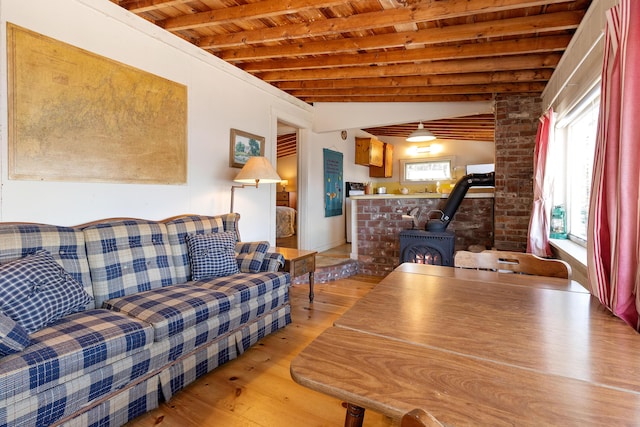 57 Samoset Trl, Boothbay, ME 04544 - living room with light wood-style floors, a wood stove, beam ceiling, and wood ceiling