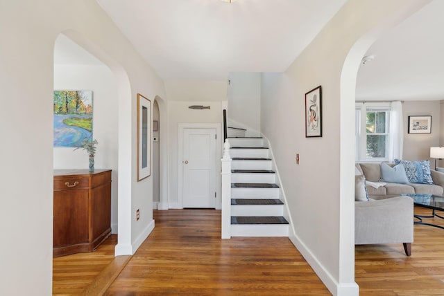 72 US Route 1, Falmouth, ME 04105 - stairway with arched walkways, wood finished floors, and baseboards