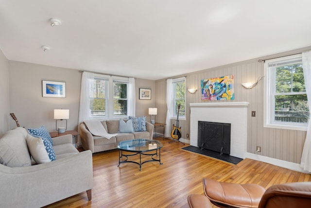 72 US Route 1, Falmouth, ME 04105 - living room featuring wood finished floors, baseboards, and a fireplace
