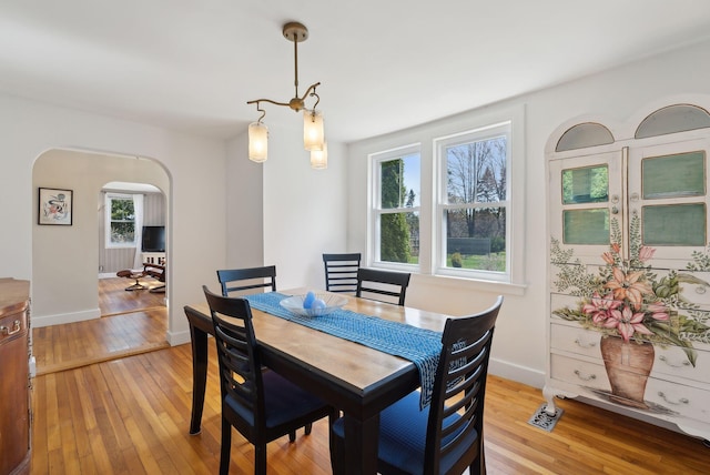 72 US Route 1, Falmouth, ME 04105 - dining space with arched walkways, light wood finished floors, and baseboards