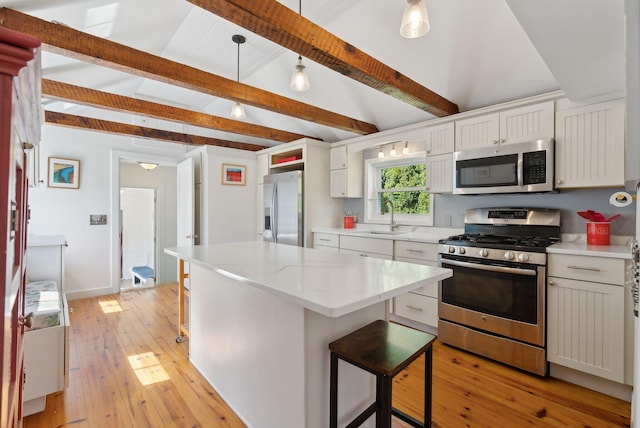 72 US Route 1, Falmouth, ME 04105 - kitchen with stainless steel appliances, a sink, light wood finished floors, and a breakfast bar