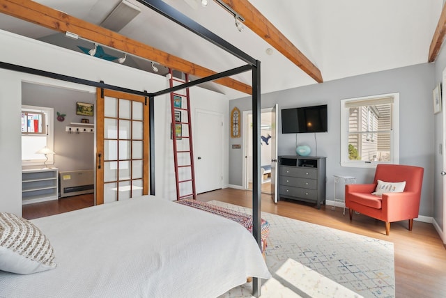 72 US Route 1, Falmouth, ME 04105 - bedroom with wood finished floors, a barn door, and baseboards