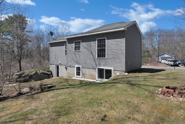 rear view of property featuring an outdoor fire pit and a lawn