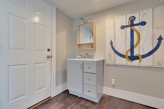 bathroom with vanity, baseboards, and wood finished floors