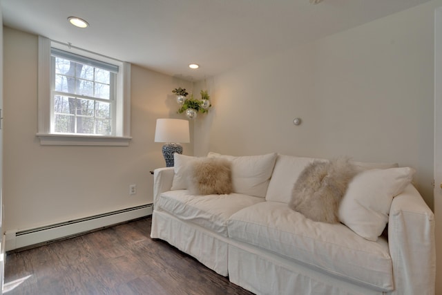 living room with dark wood-type flooring, a baseboard heating unit, and recessed lighting