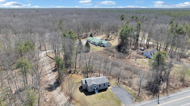 bird's eye view with a wooded view