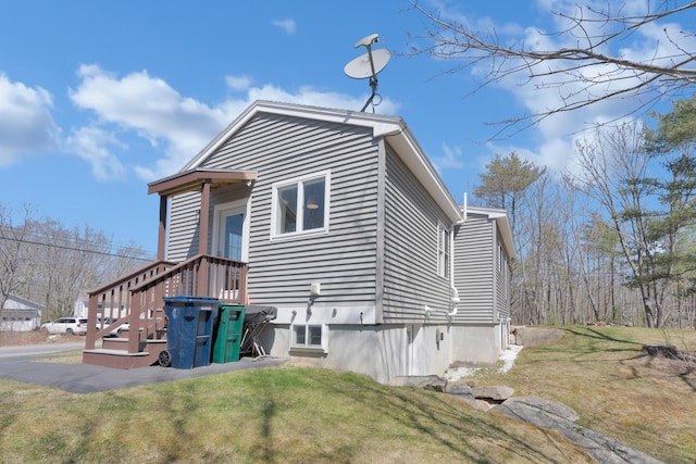 view of side of property with a lawn