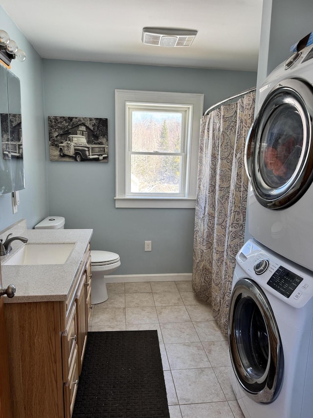 441 Works Rd, Jackson, ME 04921 - full bath with toilet, visible vents, tile patterned flooring, stacked washer and dryer, and vanity