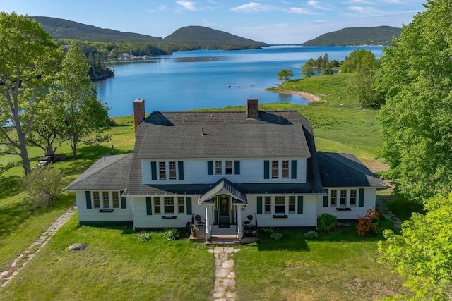 480 Sound Dr, Mount Desert, ME 04660 - view of front of house featuring a front yard, a porch, a chimney, and a water and mountain view