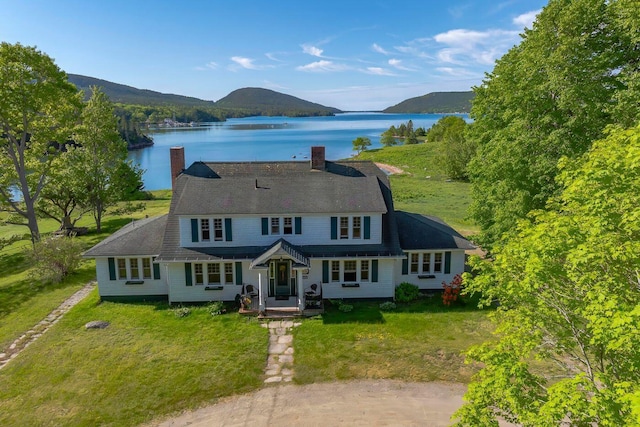 480 Sound Dr, Mount Desert, ME 04660 - view of front of house with a gambrel roof, a front lawn, a water and mountain view, and a chimney
