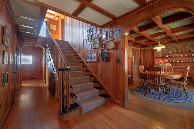 480 Sound Dr, Mount Desert, ME 04660 - stairs featuring arched walkways, wooden walls, hardwood / wood-style flooring, and beamed ceiling