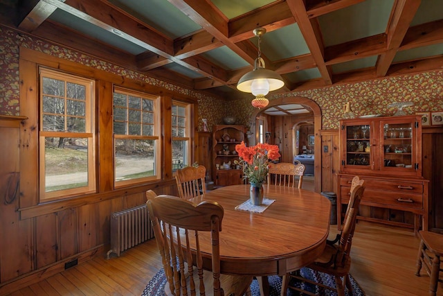 480 Sound Dr, Mount Desert, ME 04660 - dining space with arched walkways, light wood-type flooring, wallpapered walls, and radiator