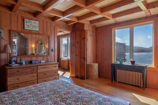 480 Sound Dr, Mount Desert, ME 04660 - bedroom with coffered ceiling, radiator, wooden walls, and wood finished floors
