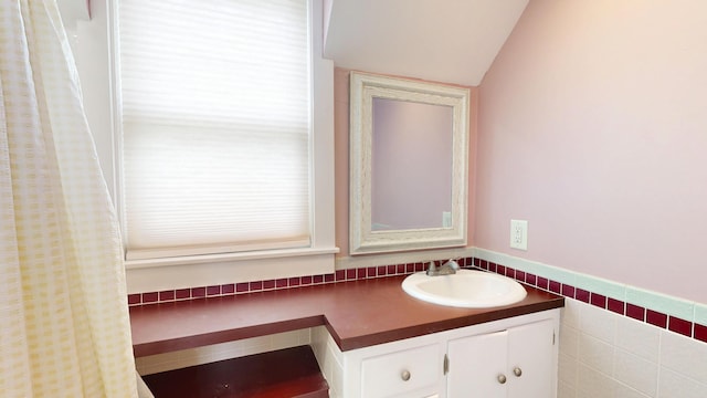 19 Spruce Head Rd, South Thomaston, ME 04858 - bathroom with vanity, vaulted ceiling, and a wainscoted wall
