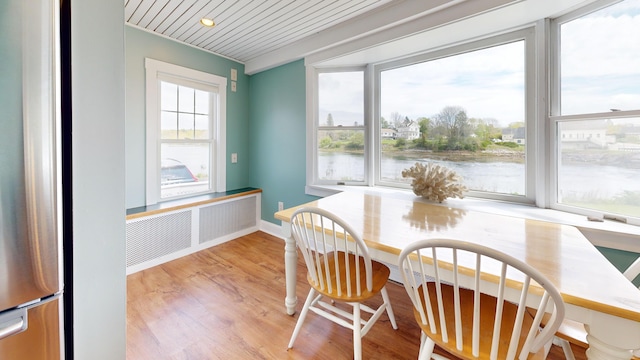 19 Spruce Head Rd, South Thomaston, ME 04858 - dining room featuring a water view, light wood finished floors, and radiator