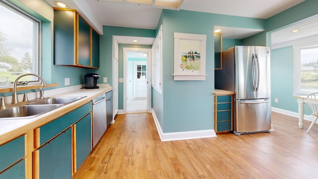 19 Spruce Head Rd, South Thomaston, ME 04858 - kitchen with stainless steel appliances, a sink, light wood-style floors, light countertops, and baseboards
