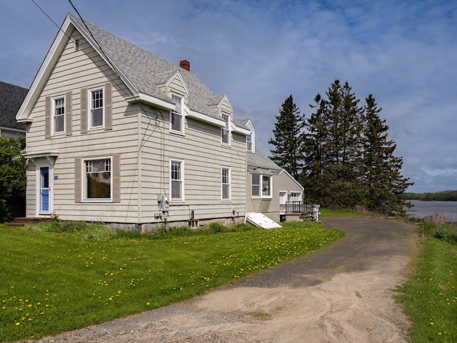 19 Spruce Head Rd, South Thomaston, ME 04858 - view of side of property with a chimney, a yard, and roof with shingles