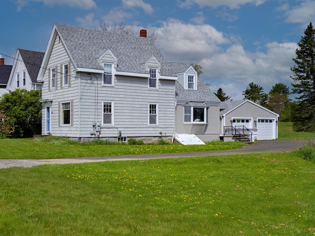 19 Spruce Head Rd, South Thomaston, ME 04858 - view of front of house featuring a detached garage, a chimney, a shingled roof, and a front yard