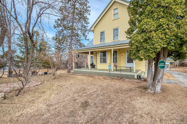 27 Pine St, Eustis, ME 04936 - view of front of property featuring covered porch, metal roof, and a standing seam roof