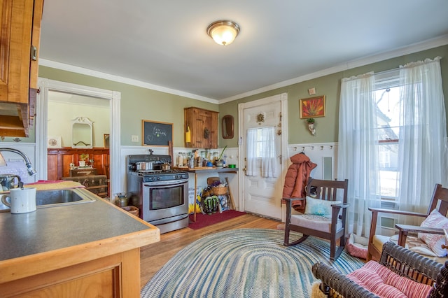 27 Pine St, Eustis, ME 04936 - kitchen with gas stove, a sink, healthy amount of natural light, a wainscoted wall, and light wood-style floors