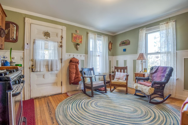 27 Pine St, Eustis, ME 04936 - living area with wainscoting, light wood-style flooring, and ornamental molding
