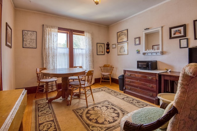 27 Pine St, Eustis, ME 04936 - dining area featuring wood finished floors, ornamental molding, and baseboards