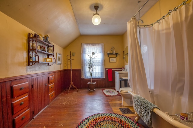 27 Pine St, Eustis, ME 04936 - bathroom with wood-type flooring, a wainscoted wall, lofted ceiling, toilet, and wooden walls