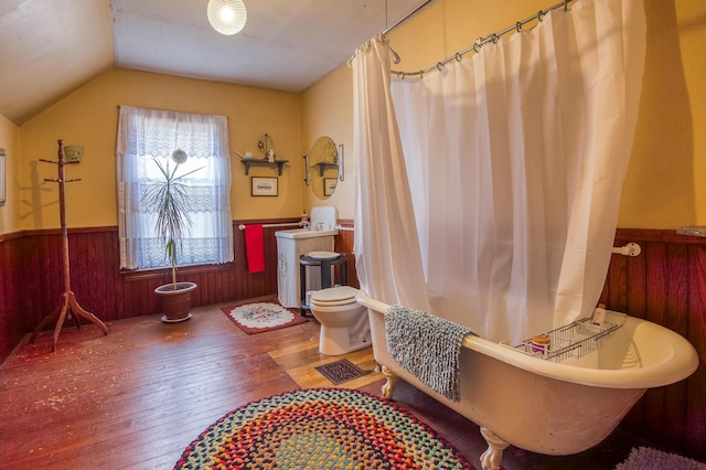 27 Pine St, Eustis, ME 04936 - bathroom featuring hardwood / wood-style floors, wainscoting, a freestanding tub, lofted ceiling, and wooden walls