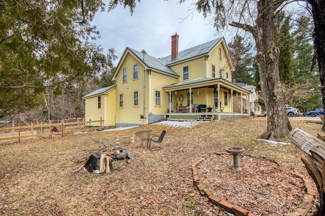 27 Pine St, Eustis, ME 04936 - back of house with a porch, fence, metal roof, a chimney, and a standing seam roof