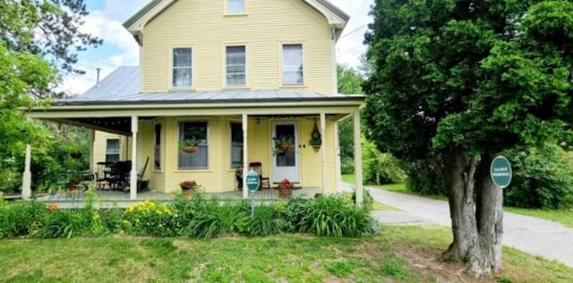 27 Pine St, Eustis, ME 04936 - view of front of home featuring a porch and a front lawn