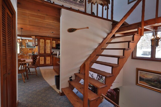 stairs featuring an inviting chandelier