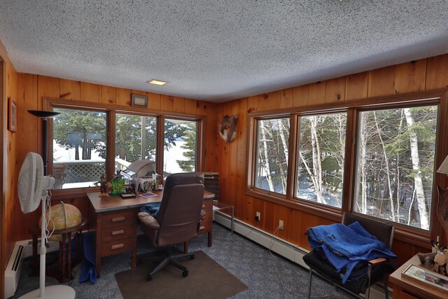 office with a textured ceiling, wooden walls, and a baseboard radiator